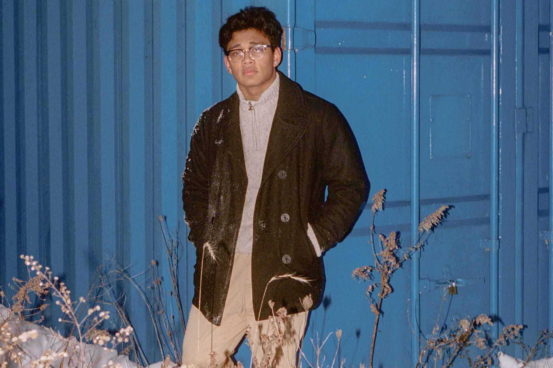 Avi Roy leaning against a shipping container