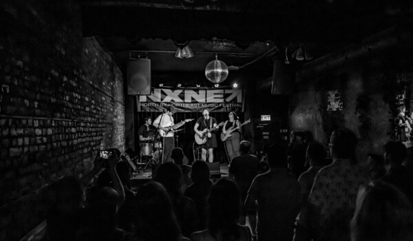 Alanna Matty and band performing to a packed crowd.